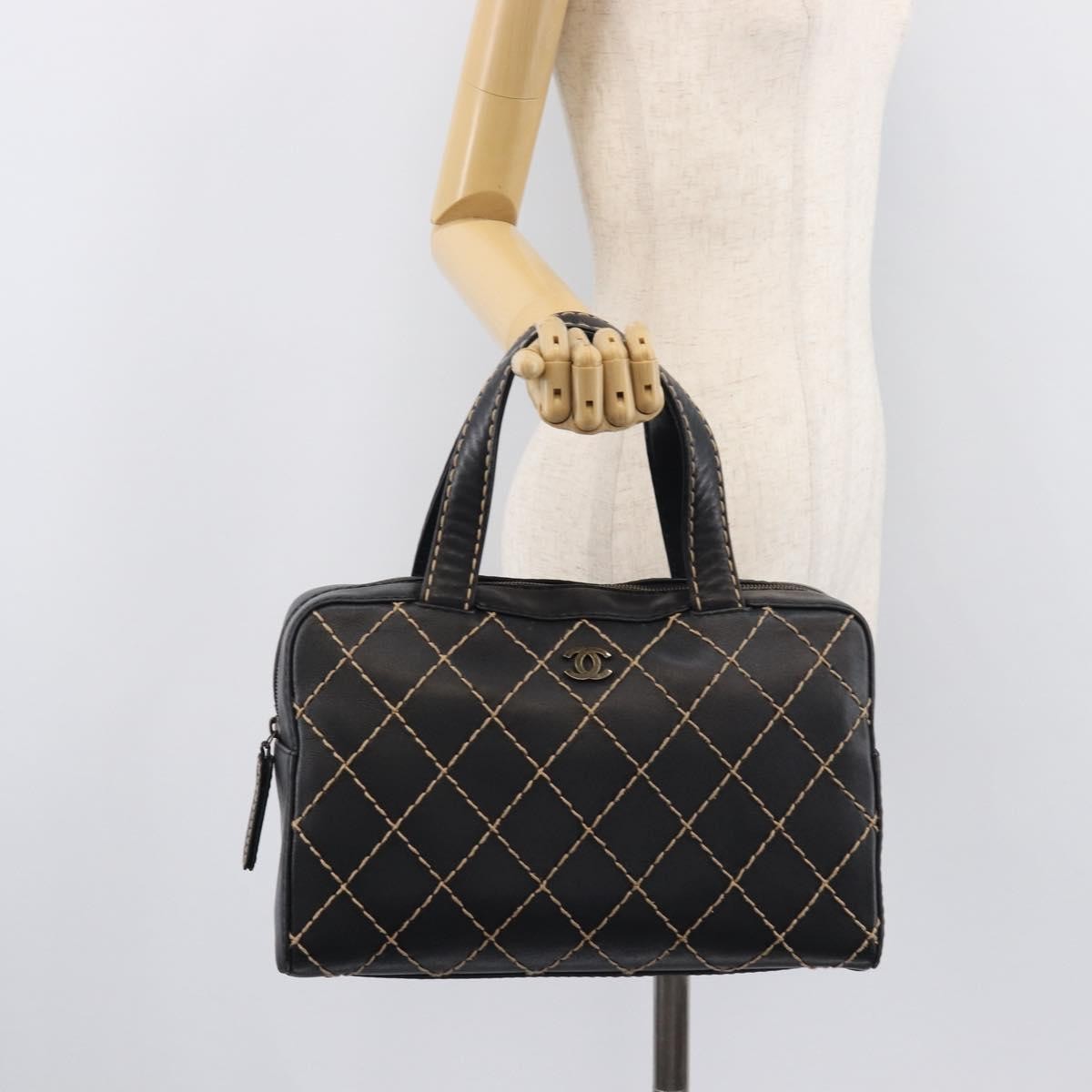 Chanel Surpique Boston Quilted Leather Black Leather Handbag (Pre-Owned)